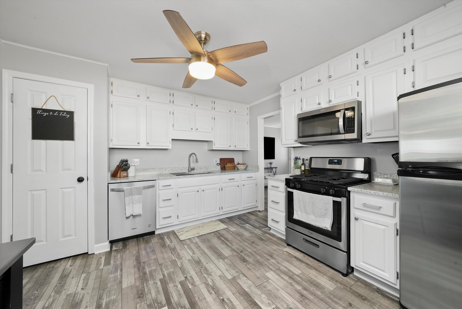 3908 Owl Drive Rolling Meadows, IL 60008 - Photo 10 of 36 a kitchen with stainless steel appliances a stove a sink and white cabinets