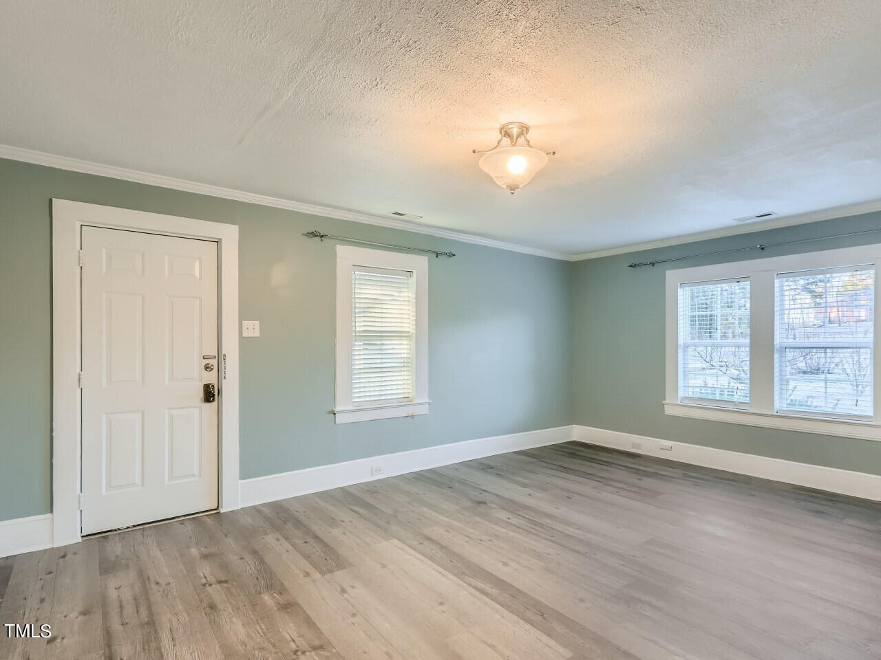 2403 Cheek Road Durham, NC 27704 - Photo 8 of 30 an empty room with wooden floor and windows