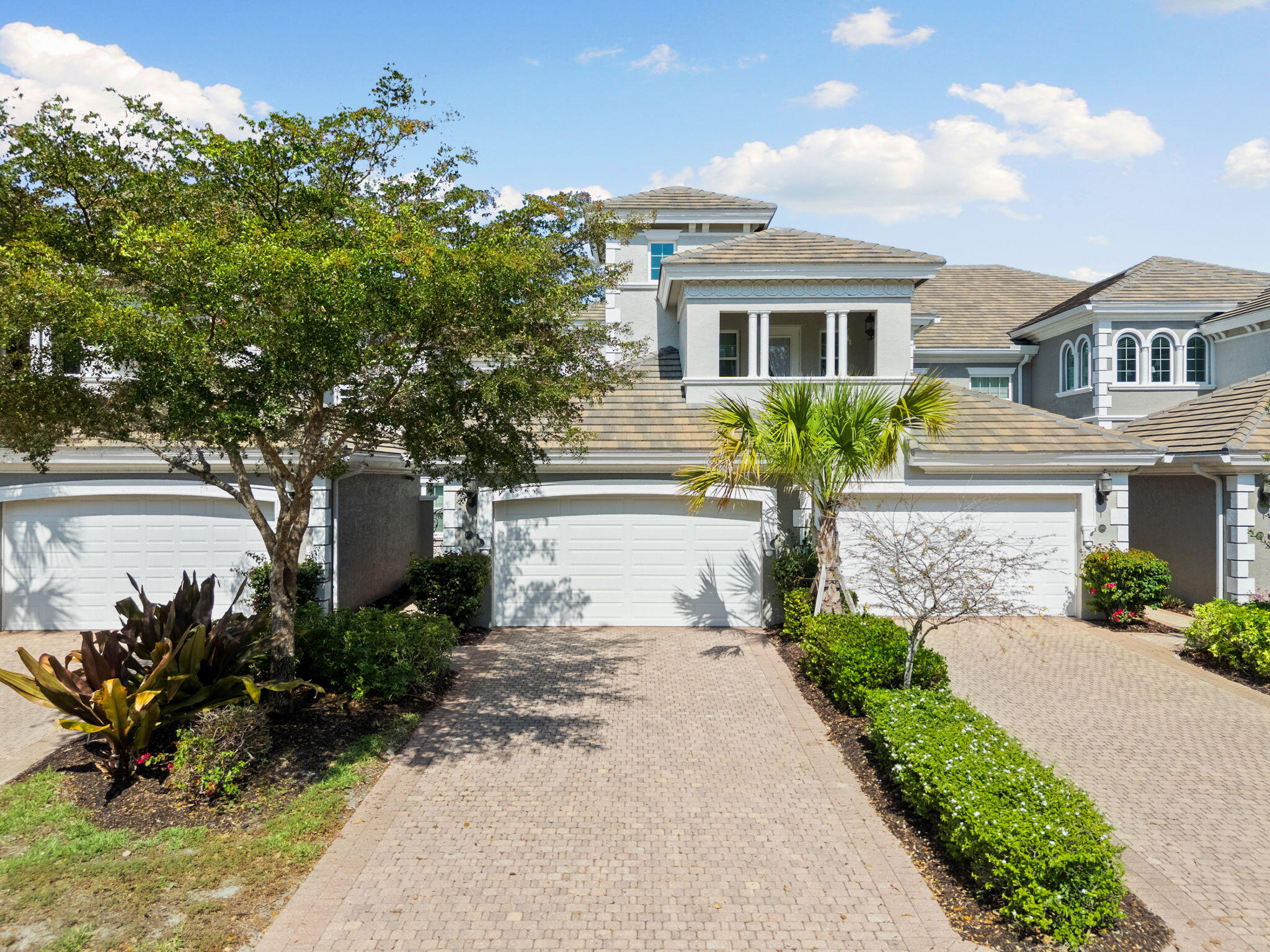 9213 Museo Circle, Unit 103 Naples, FL 34114 - Photo 2 of 47 a front view of a house with a garden and outdoor seating