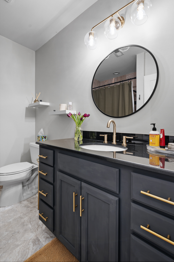 3918 West Roscoe Street, Unit 2 Chicago, IL 60618 - Photo 12 of 19 a bathroom with a sink and a mirror