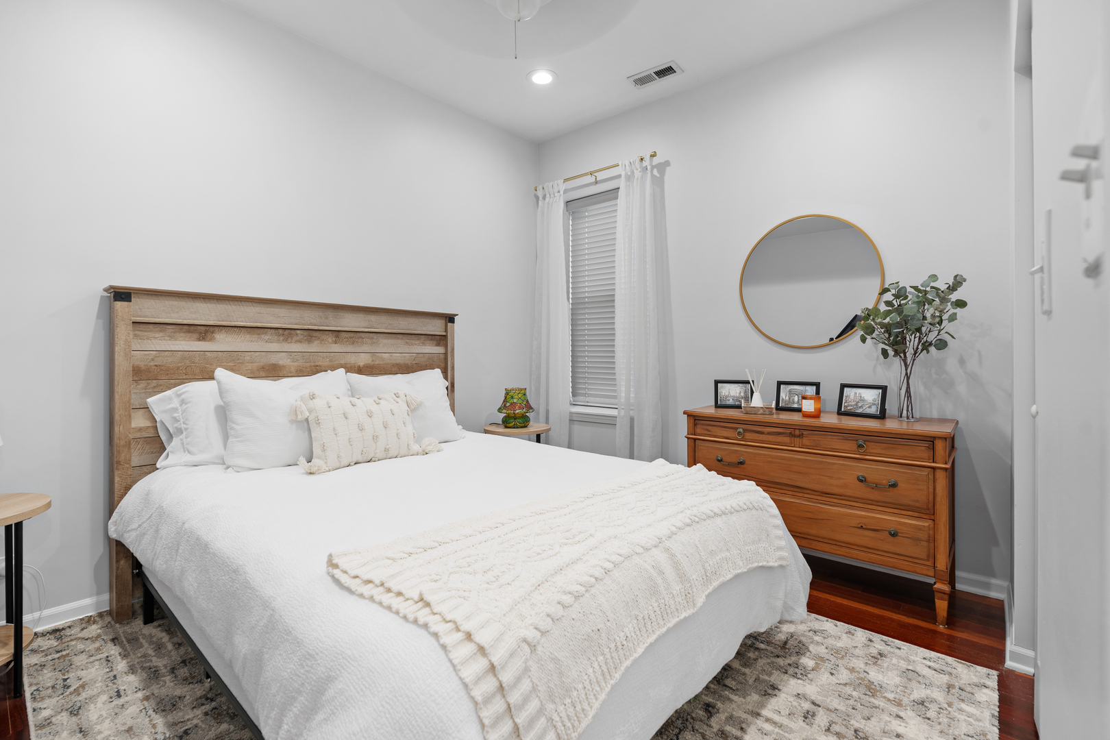 3918 West Roscoe Street, Unit 2 Chicago, IL 60618 - Photo 13 of 19 a bedroom with a bed and a mirror