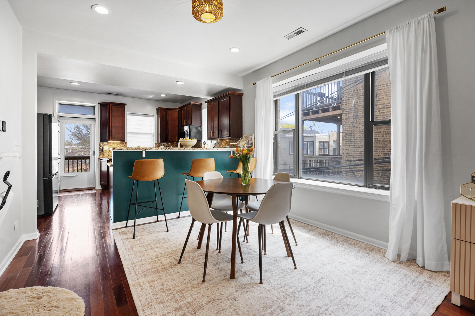 3918 West Roscoe Street, Unit 2 Chicago, IL 60618 - Photo 5 of 19 a view of a dining room with furniture and wooden floor