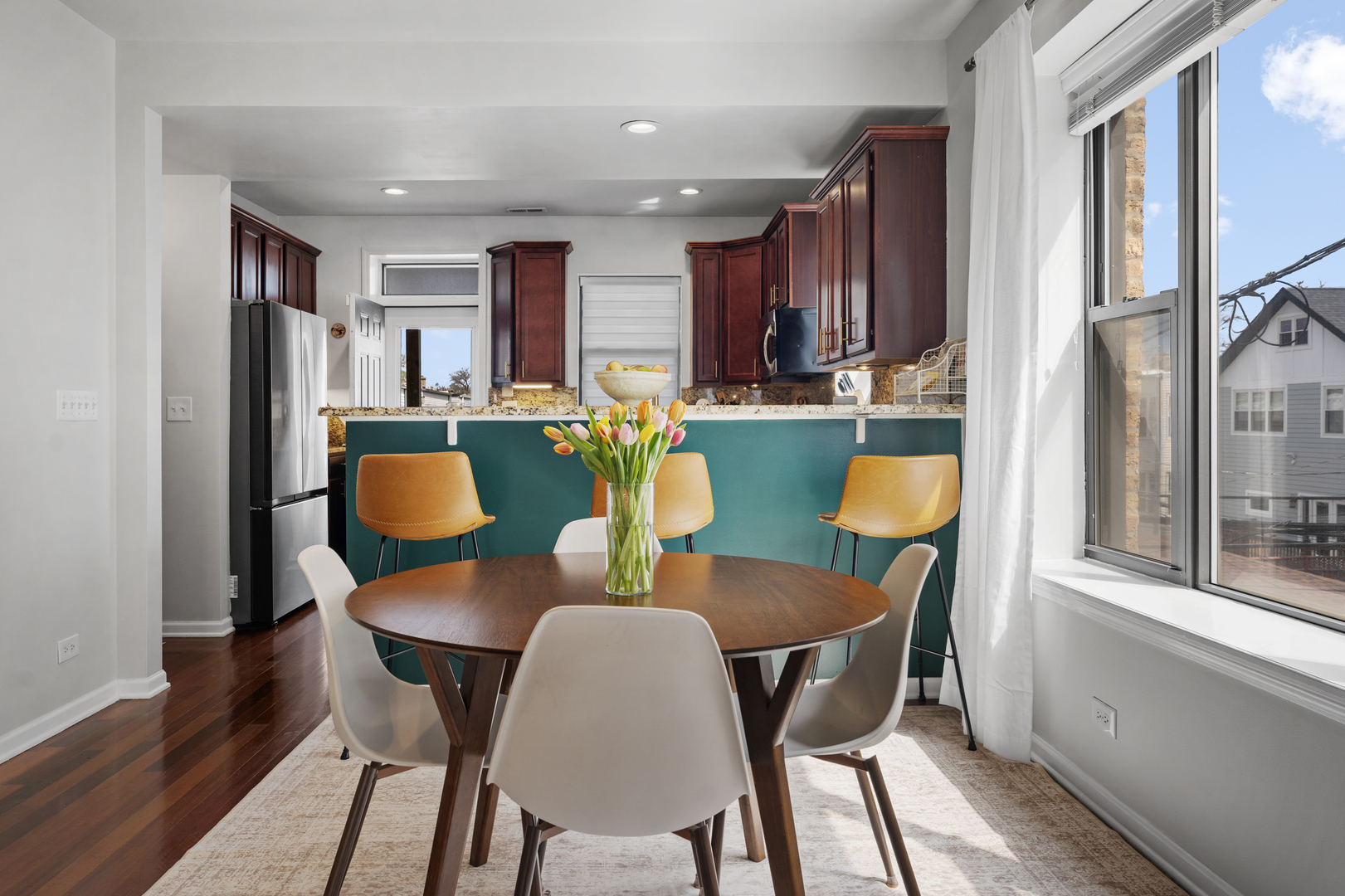 3918 West Roscoe Street, Unit 2 Chicago, IL 60618 - Photo 6 of 19 a view of a dining room with furniture and a window