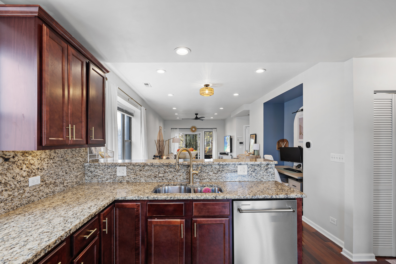 3918 West Roscoe Street, Unit 2 Chicago, IL 60618 - Photo 8 of 19 a kitchen with kitchen island granite countertop stainless steel appliances sink stove and cabinets