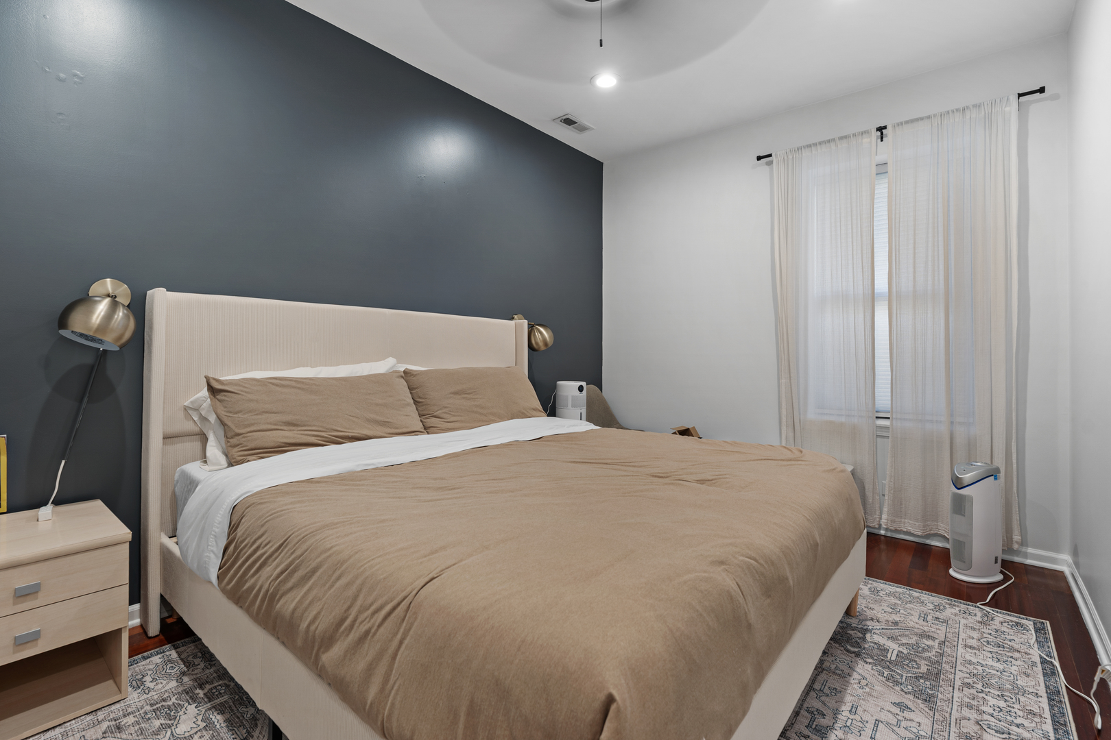 3918 West Roscoe Street, Unit 2 Chicago, IL 60618 - Photo 10 of 19 a large bed sitting in a bedroom next to a cabinet