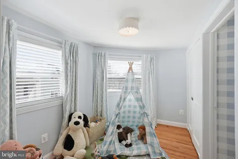 a view of a room with wooden floor and windows