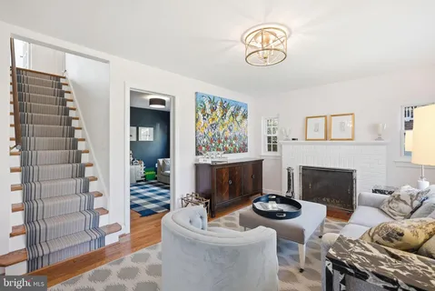 a living room with furniture a fireplace and a window