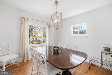 a view of a dining room with furniture wooden floor and a chandelier