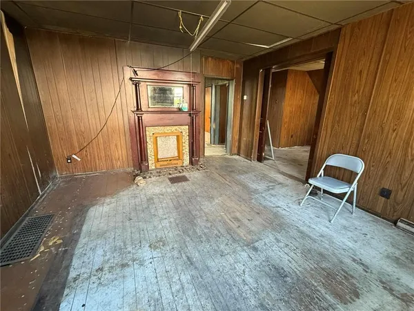 a view of an empty room with a fireplace
