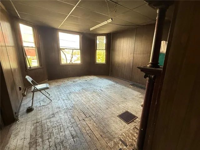 a view of livingroom with hardwood floor and front door
