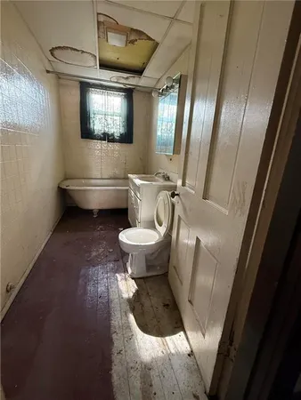 a bathroom with a toilet sink and mirror