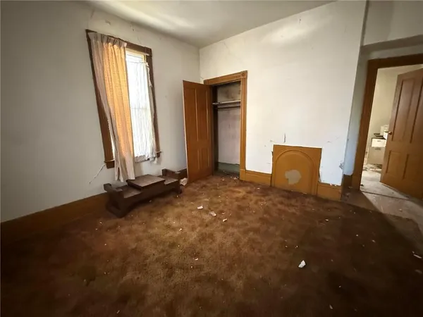 a view of a room with a mirror and windows