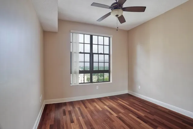 a bathroom with a glass shower door and a window