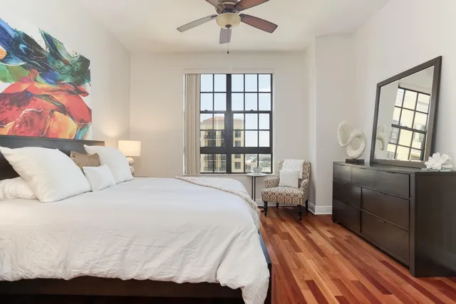a bedroom with a bed and wooden floor
