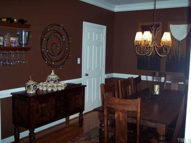 5824 Ventry Court Raleigh, NC 27613 - Photo 7 of 12 Spacious dining room with chair rail and crown molding. Newly refinished oak hardwood floors. Two windows (not seen in pictures) look out into the beautifully landscaped front yard. Dining Room