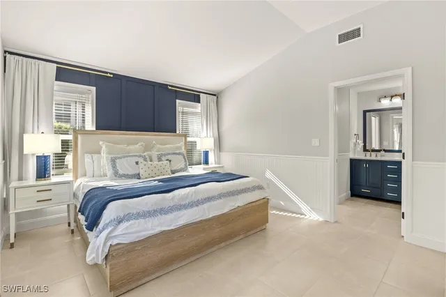 a bathroom with a granite countertop toilet sink and mirror