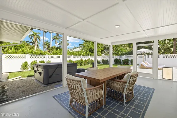 a view of a patio with a table and chairs