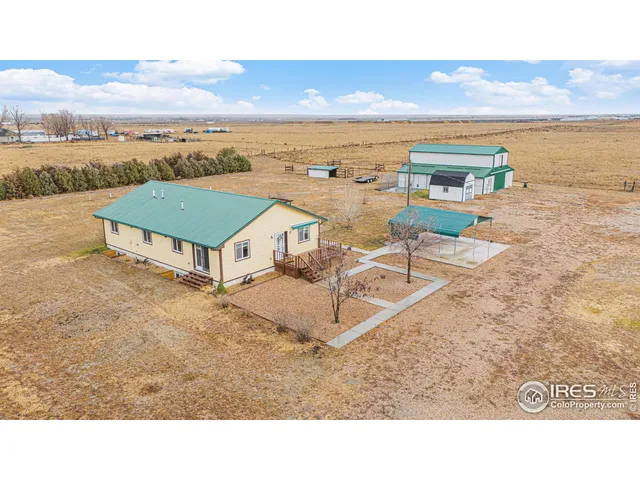 a view of house with yard and lake view