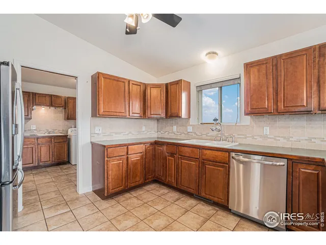a view of a kitchen with a sink and a fireplace