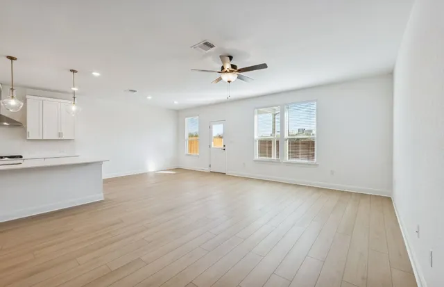 a view of a livingroom with a ceiling fan and entryway