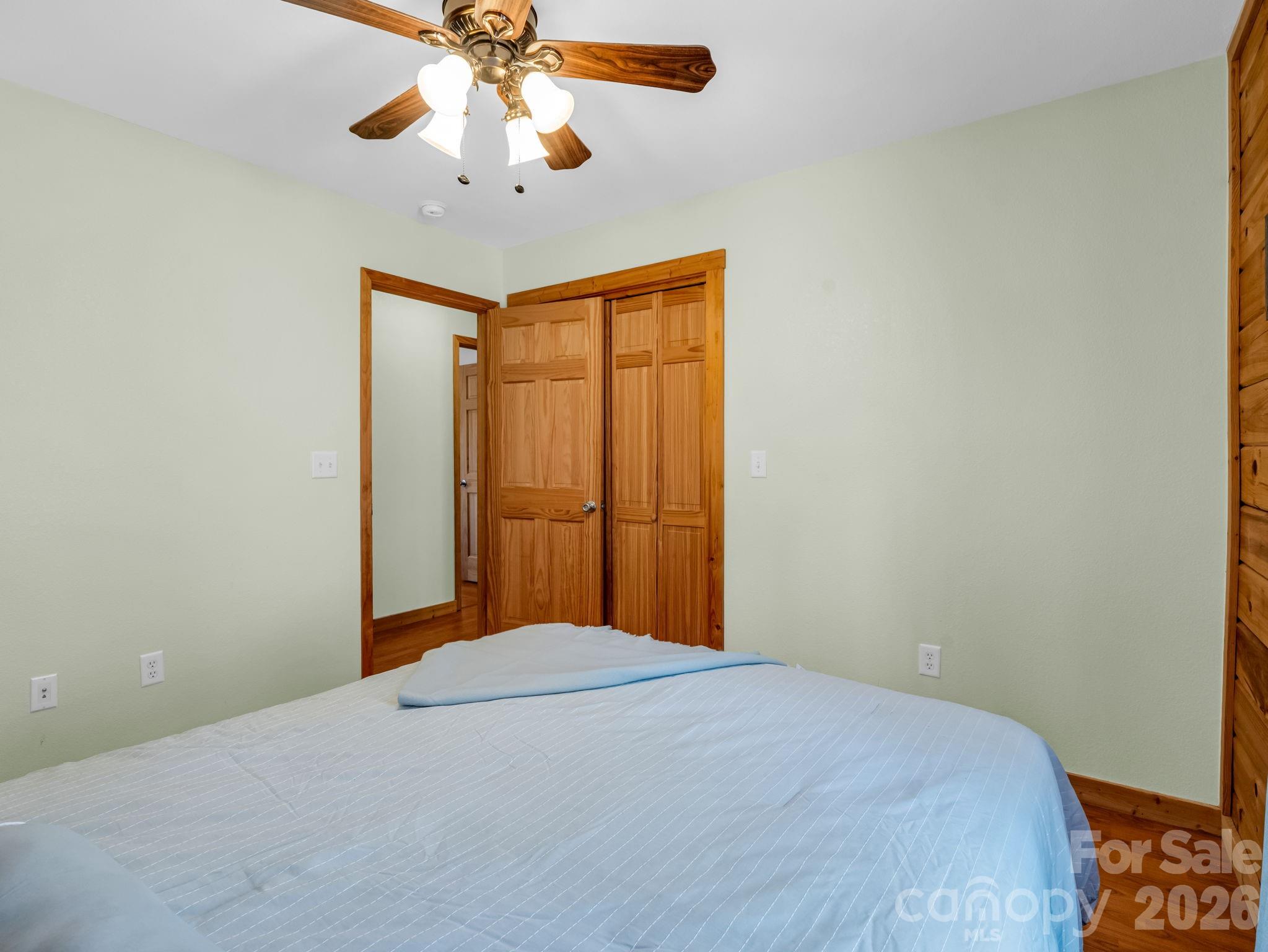 1050 Cross Ridge Drive Rutherfordton, NC 28139 - Photo 25 of 48 a bedroom with a bed and a chandelier