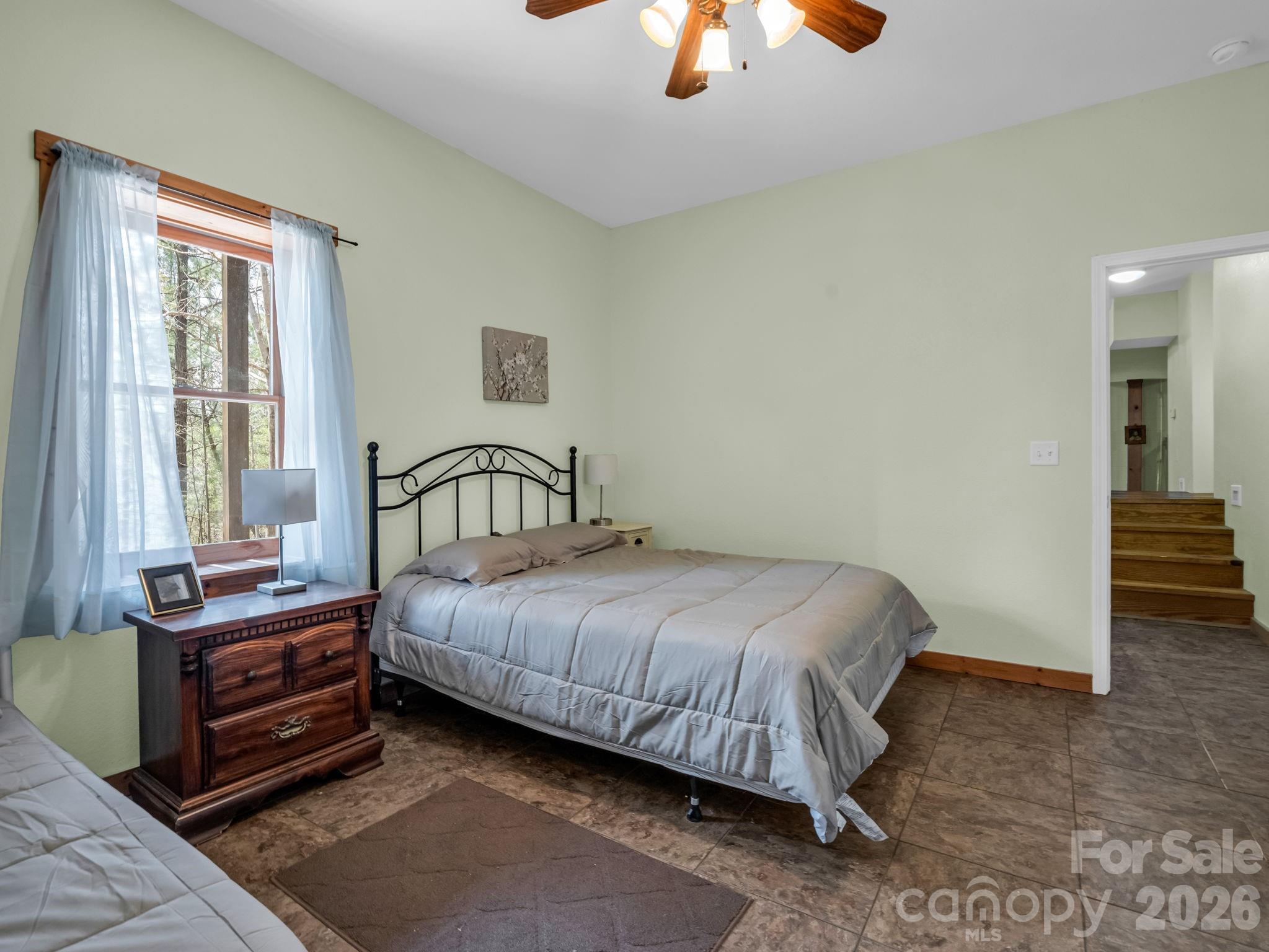 1050 Cross Ridge Drive Rutherfordton, NC 28139 - Photo 38 of 48 a bedroom with a bed a chandelier and next to a window