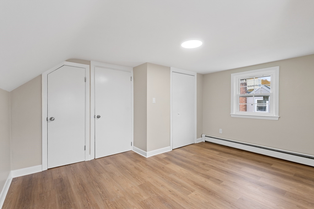 63 Hope Street Attleboro, MA 02703 - Photo 17 of 27 a view of an empty room with wooden floor and a window
