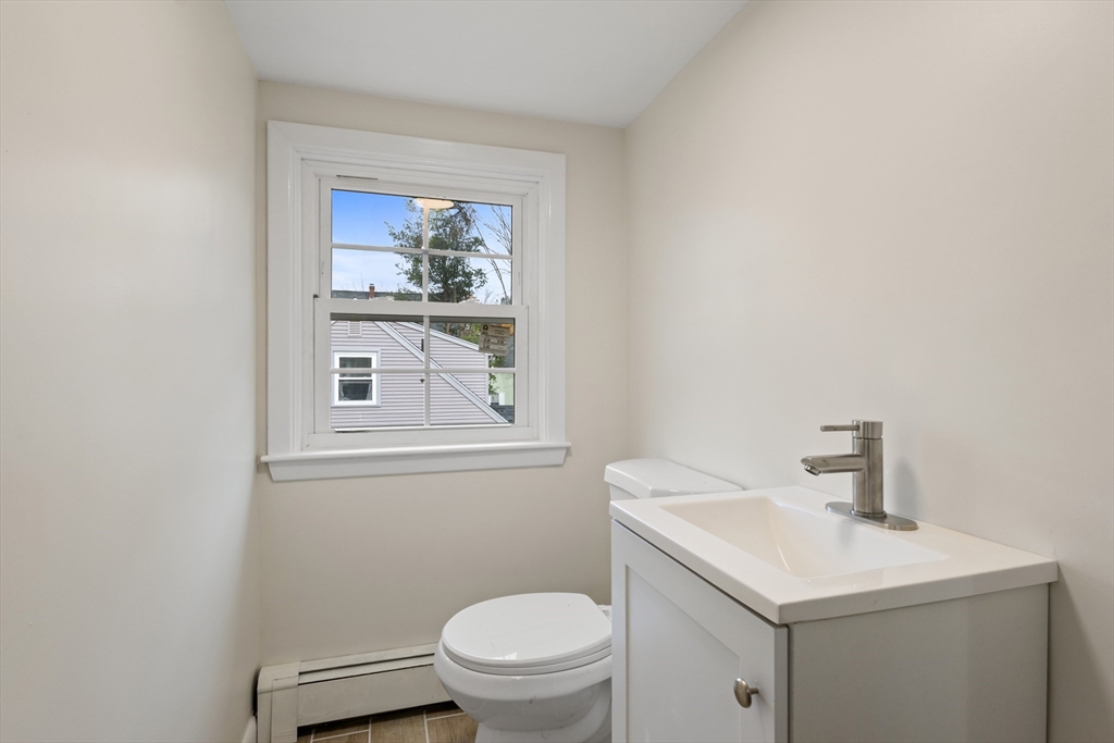 63 Hope Street Attleboro, MA 02703 - Photo 18 of 27 a bathroom with a toilet sink and mirror