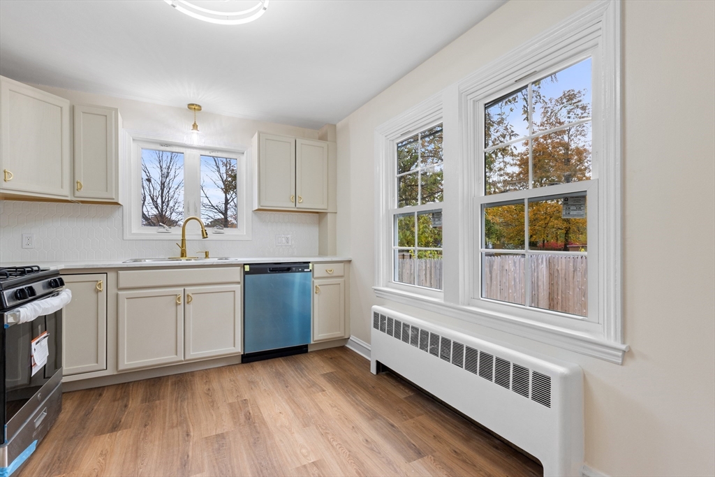 63 Hope Street Attleboro, MA 02703 - Photo 2 of 27 a kitchen with a window a sink and a white cabinets