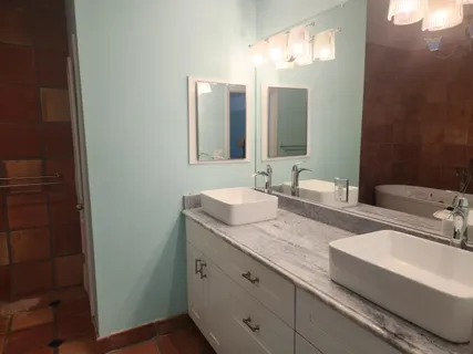 a bathroom with a granite countertop sink and a mirror