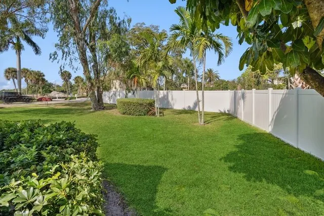 a view of yard with swimming pool and green space