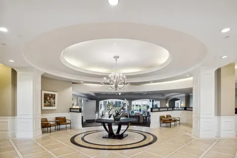 a living room with couch and a chandelier