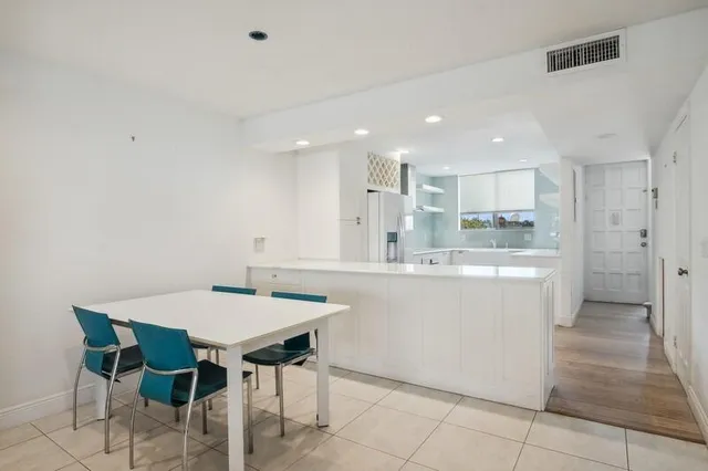 a kitchen with a table and chairs in it
