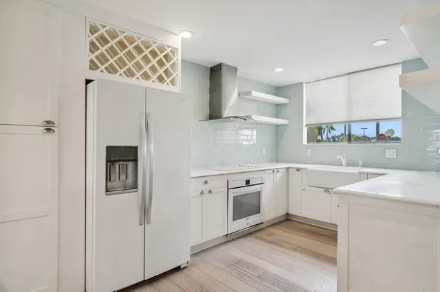 a kitchen with cabinets and wooden floor