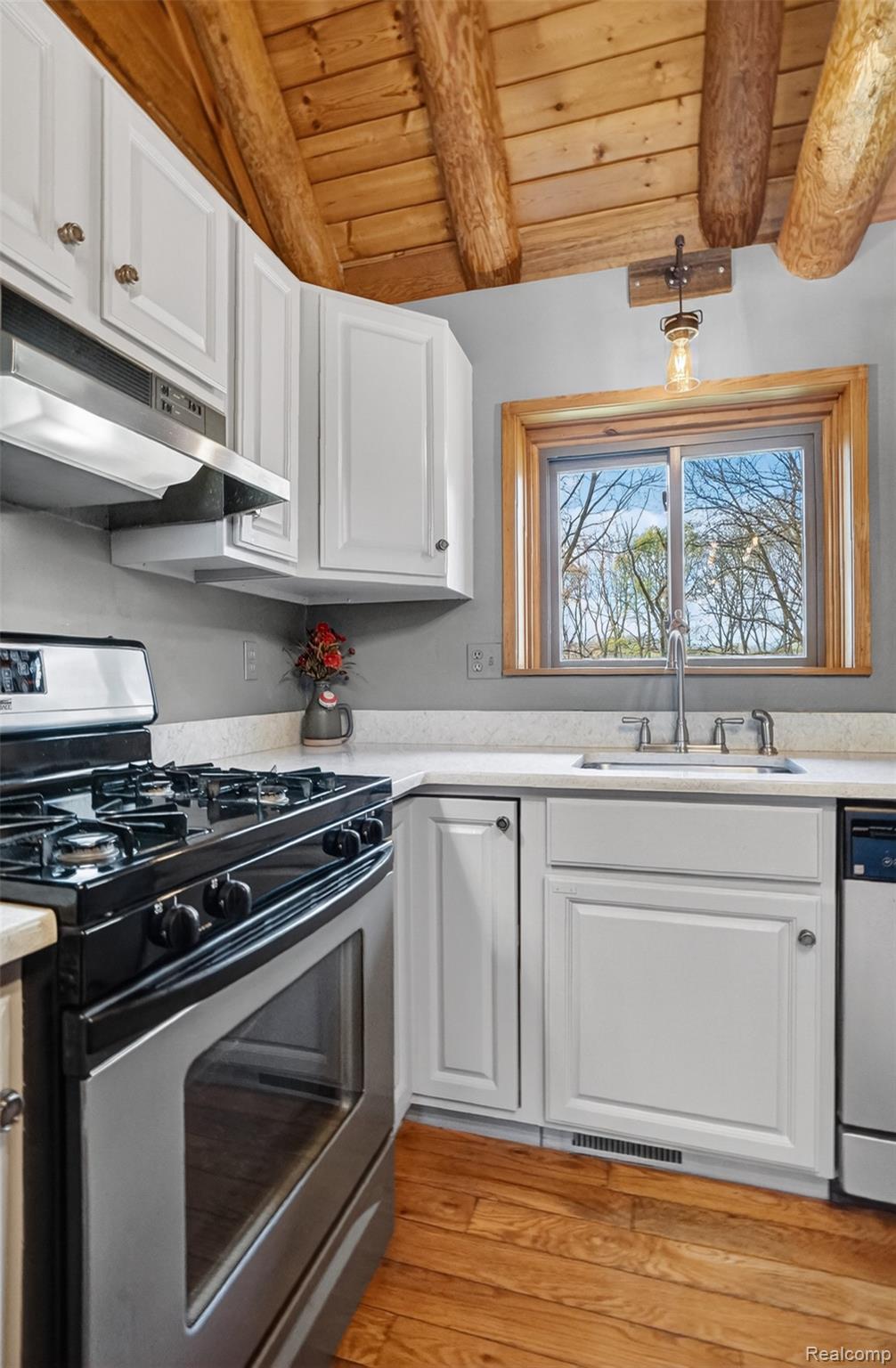 2997 Brighton Road Howell, MI 48843 - Photo 14 of 30 Kitchen with stainless steel appliances, white cabinetry, wood ceiling, light wood finished floors, and lofted ceiling with beams