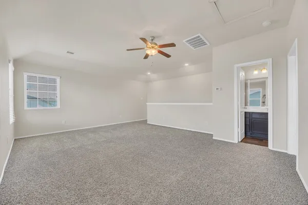 an empty room with closet and windows