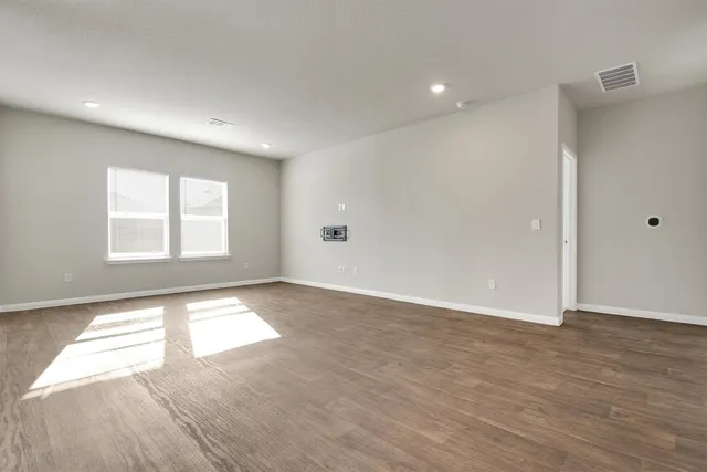 an empty room with windows and closet