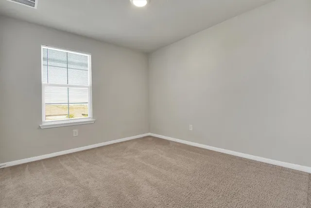 a bathroom with a granite countertop sink a toilet and a mirror