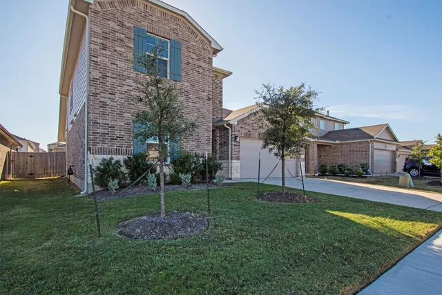 a brick building with a yard in front of it