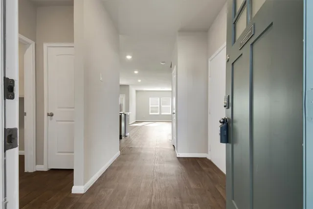 a view of hallway with wooden floor