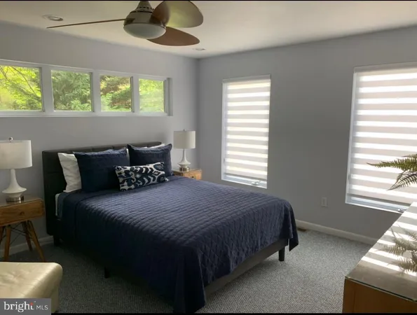 a bedroom with bed and window