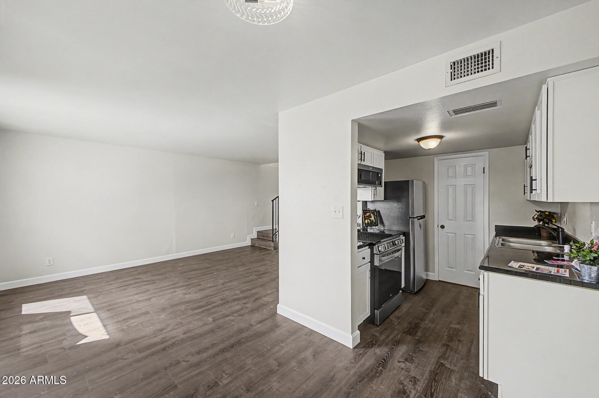 600 South Dobson Road, Unit 177 Mesa, AZ 85202 - Photo 6 of 24 a kitchen with a refrigerator and a stove top oven