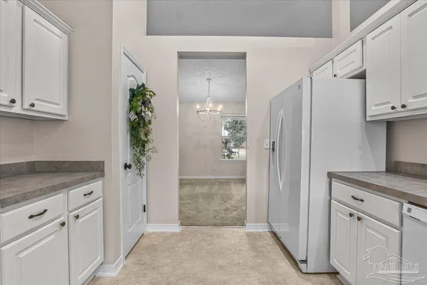 a kitchen with granite countertop a sink and cabinets