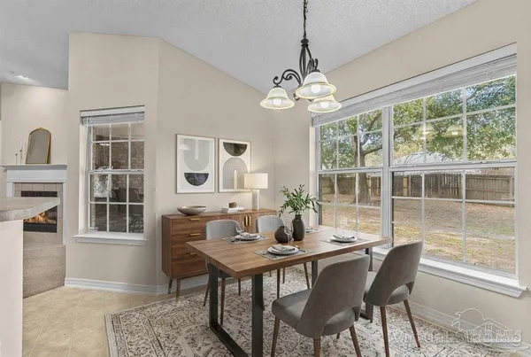 a living room with furniture a fireplace and a chandelier