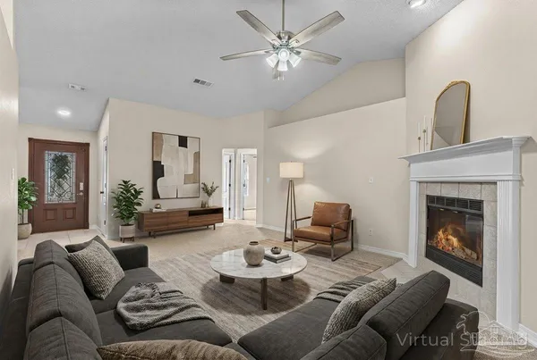 a bedroom with a bed a couches and large windows