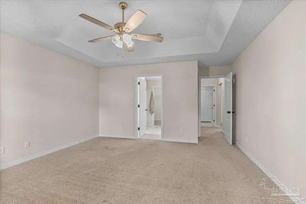 a view with white cabinets a sink and a mirror