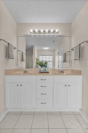 a white bath tub sitting in a bathroom next to a window