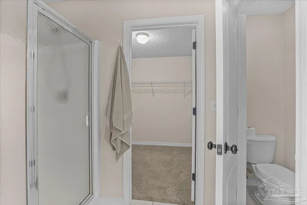 an empty room with a window and a ceiling fan