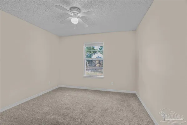 a dining room with furniture and a window