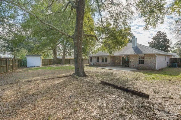 a view of a house with a yard and tree